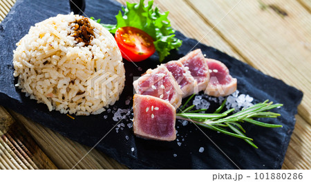 Deliciously lightly fried tuna with rice, served with greens and tomatoe Deliciously lightly fried tuna with rice, served with greens and tomatoe 101880286