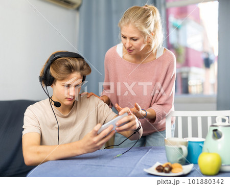 Mother asking for attention of her teenager son Mother asking for attention of her teenager son 101880342