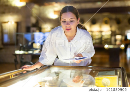 Woman looking at the exposition of mediaeval boxes 101880906