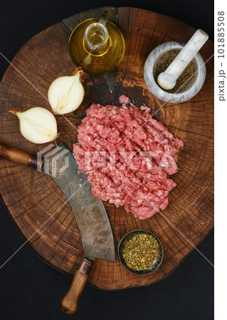 Making fresh mince meat with chopping knife, overhead view. Making fresh mince meat with chopping knife, overhead view. 101885508