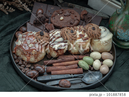 Assorted Cinnamon Rolls, Dark chocolate bars, cookies, pieces and balls. Assorted Cinnamon Rolls, Dark chocolate bars, cookies, pieces and balls. 101887858