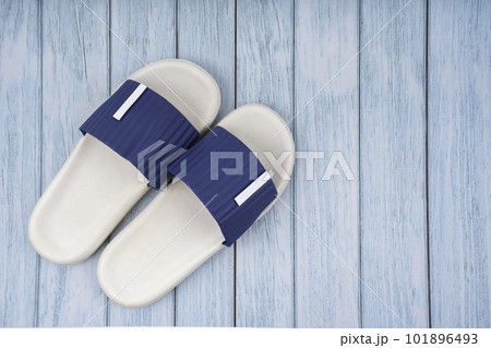 The Top view of white and blue color rubber slipper shoes on blue wooden background with copy space. Summer holiday vacation concept. 101896493
