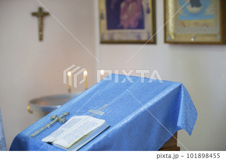 The cross and the book of the Bible lie on the church table. Religion The cross and the book of the Bible lie on the church table. Religion 101898455