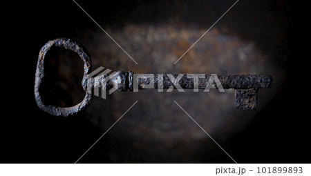 Rusty vintage key on a dark corrosion background 101899893