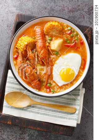 Chupe De Camarones Peruvian Shrimp Chowder close-up on a bowl. Vertical top view 101900734