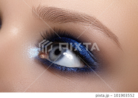 Closeup Macro of Woman Face with Blue Eyes Make-up. Fashion Celebrate Makeup, Glowy Clean Skin, perfect Shapes of Brows 101903552