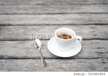 small white coffee cup on grey grunge wooden table small white coffee cup on grey grunge wooden table 101903864
