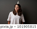 Calm relaxed teen girl standing wiht badminton shuttlecock on her head 101905815