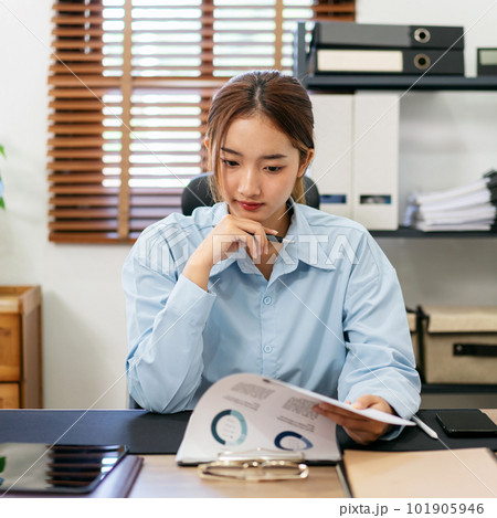 Businesswoman is thoughtful about accounting of business while r 101905946