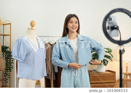 Female online seller is using smartphone to broadcast live on Vl 101906533
