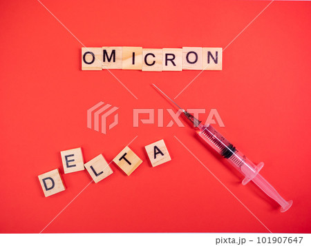Omicron variant replaces Delta. Emergence of new dangerous strain of coronavirus COVID-19 Omicron. Syringe. Words omicron delta on colored red background 101907647