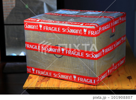 Fragile marked parcel, Cardboard boxes with Fragile symbol on wooden table. Fragile marked parcel, Cardboard boxes with Fragile symbol on wooden table. 101908807