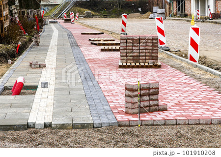 Paving of a new sidewalk with a bike lane and guidelines for the visually impaired, tactile paving Paving of a new sidewalk with a bike lane and guidelines for the visually impaired, tactile paving 101910208