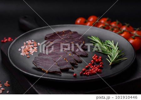 Delicious dried smoked beef or horse meat jerky with spices and salt 101910446