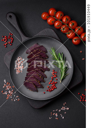 Delicious dried smoked beef or horse meat jerky with spices and salt 101910449