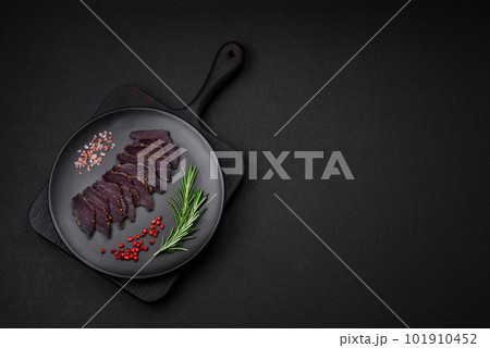 Delicious dried smoked beef or horse meat jerky with spices and salt 101910452