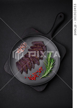 Delicious dried smoked beef or horse meat jerky with spices and salt Delicious dried smoked beef or horse meat jerky with spices and salt 101910453