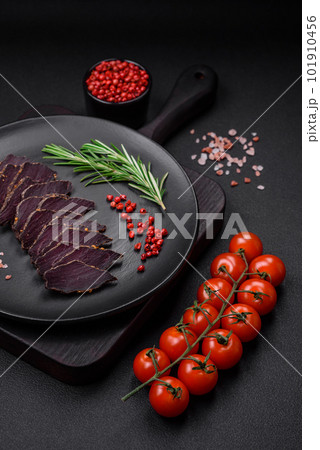 Delicious dried smoked beef or horse meat jerky with spices and salt 101910456
