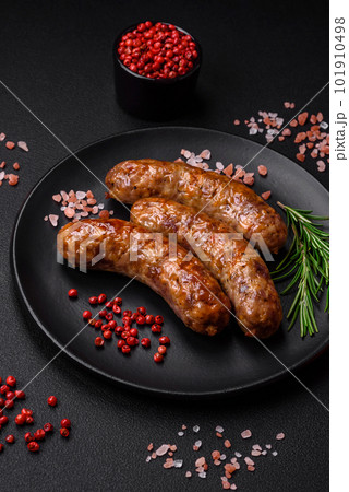 Delicious fried grilled sausages with salt, spices and herbs 101910498
