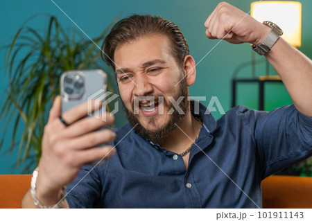 Lebanese man use smartphone celebrating winning, lottery jackpot goal achievemen, good news, victory Lebanese man use smartphone celebrating winning, lottery jackpot goal achievemen, good news, victory 101911143