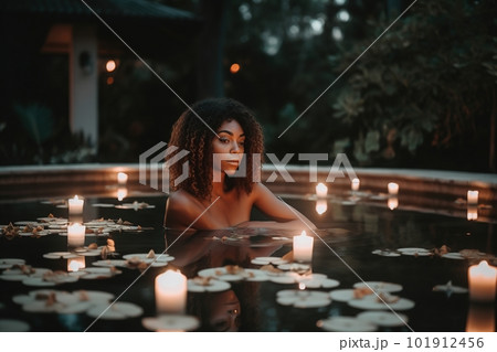 A woman in a flowing, bohemian-style two-piece swimsuit sits on the edge of a pool, surrounded by candles and flowers. The water is still and calm, creating a peaceful atmosphere. Generative AI. A woman in a flowing, bohemian-style two-piece swimsuit sits on the edge of a pool, surrounded by candles and flowers. The water is still and calm, creating a peaceful atmosphere. Generative AI. 101912456