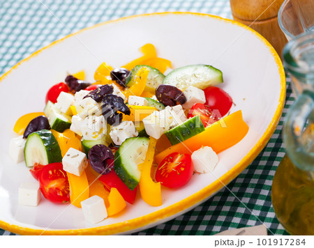 Delicious salad with tomatoes, cucumber, feta cheese and paprika Delicious salad with tomatoes, cucumber, feta cheese and paprika 101917284