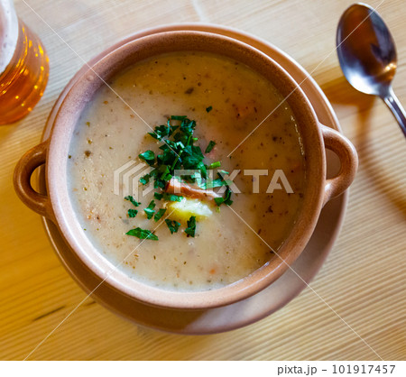 Zurek cream soup served with greens in bowl on table 101917457