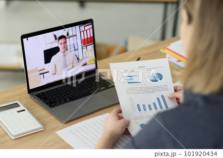 Woman examines investigation paper talking to man on video 101920434