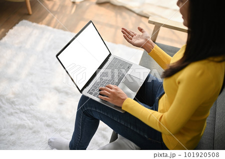 Close up view young woman making video call with her friends by using laptop 101920508