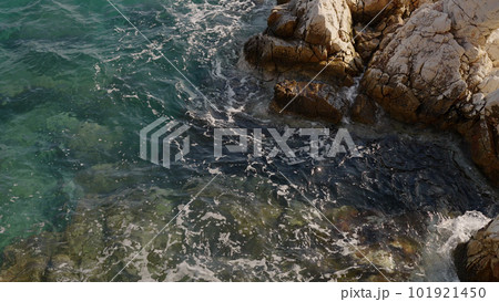 Azure waves of mediterranean sea splashing on French Riviera coast 101921450