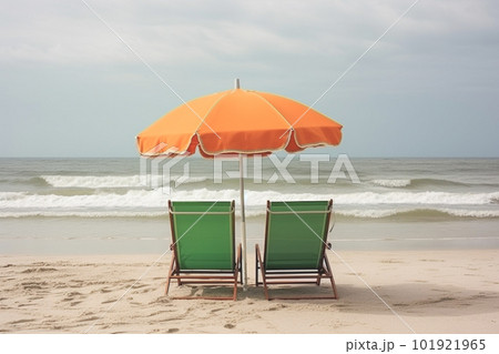 Two beach chairs and umbrella on the tropical beach with sea and sky background, vintage color tone Two beach chairs and umbrella on the tropical beach with sea and sky background, vintage color tone 101921965