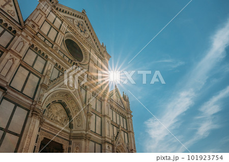 Stunning bottom-up view of Florences Cathedral of Saint Mary the Flower illuminated by the suns rays on blue summer sky. The concept of European attractions for tourist travel 101923754