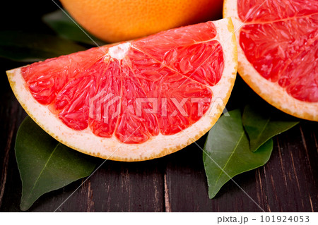 orange and grapefruit juice On a wooden black background orange and grapefruit juice On a wooden black background 101924053