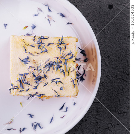 French mille feuille cake with vanilla cream decorated with blue flower leaves French mille feuille cake with vanilla cream decorated with blue flower leaves 101924935