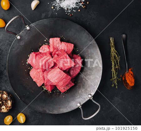 Raw meat is cut into pieces top view 101925150