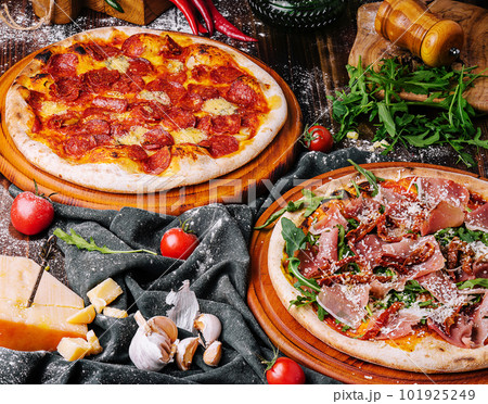 Tasty assorted three pizzas on a wooden background 101925249