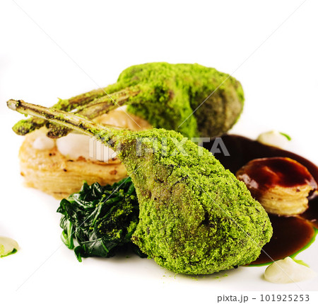Grilled rack of lamb with mint and pistachio on plate 101925253