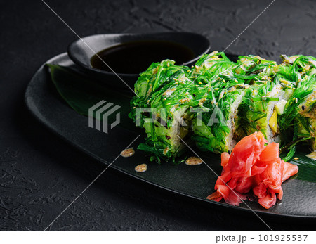set sushi rolls in seaweed on black plate set sushi rolls in seaweed on black plate 101925537