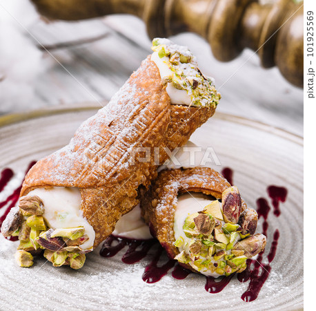 Traditional italian dessert cannoli siciliani on plate Traditional italian dessert cannoli siciliani on plate 101925569