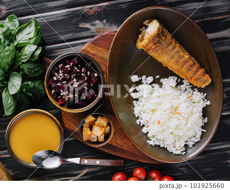 Roast fish with white rice on a cutting board 101925660