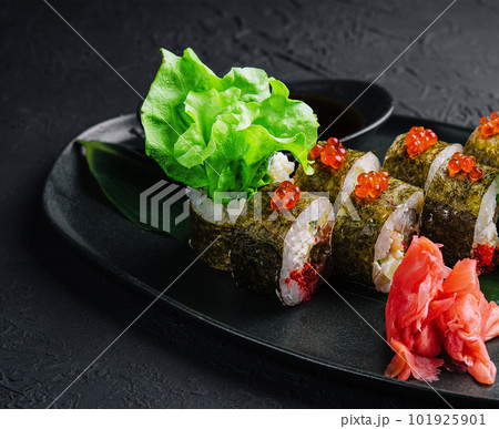 Sushi rolls served on stone slate red caviar Sushi rolls served on stone slate red caviar 101925901