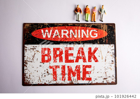Break Time Concept. Warning sign and miniature people on a white background Break Time Concept. Warning sign and miniature people on a white background 101926442