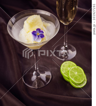 Peach and melon sorbet in bowl with a glass of champagne Peach and melon sorbet in bowl with a glass of champagne 101927281