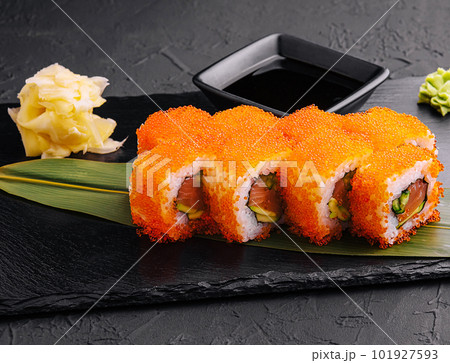 Sushi rolls philadelphia on a black slate Sushi rolls philadelphia on a black slate 101927593