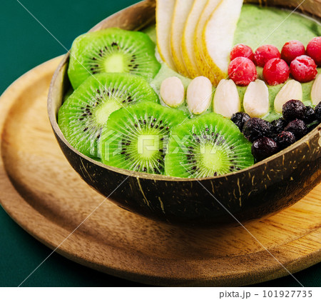 Green smoothie bowl with nuts, kiwi, pear, berry and granola Green smoothie bowl with nuts, kiwi, pear, berry and granola 101927735