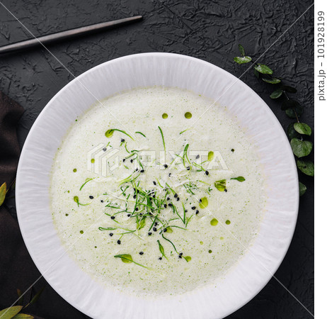 Champignon mushroom cream soup in white plate with pastry 101928199