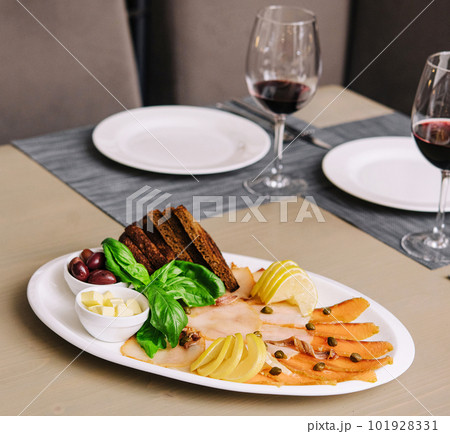 White and red smoked fish slices with glasses of wine White and red smoked fish slices with glasses of wine 101928331