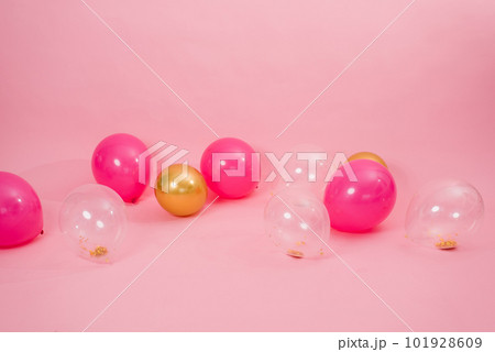 Beautiful multicolored pink, gold and transparent with confetti or sequins lie on a pink background in a chaotic order. Concept of Valentine's day, birthday, mother's day in barbiecore style Beautiful multicolored pink, gold and transparent with confetti or sequins lie on a pink background in a chaotic order. Concept of Valentine's day, birthday, mother's day in barbiecore style 101928609