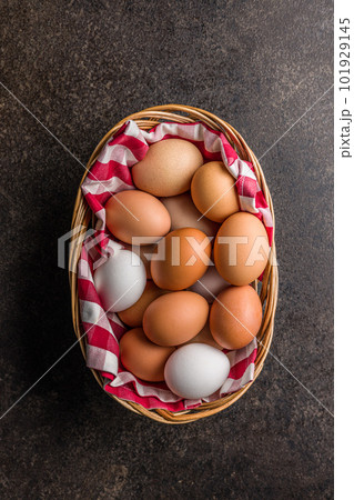 Whole chicken eggs in basket on black table. Top view. Whole chicken eggs in basket on black table. Top view. 101929145