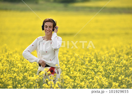 Young beautiful brunette woman girl listening music in headphones in the outdoor 101929655